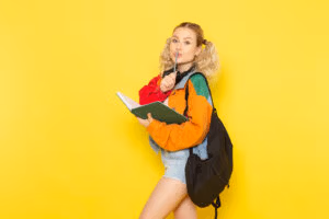 ACASĂ 6 female student young modern clothes holding copybook yellow